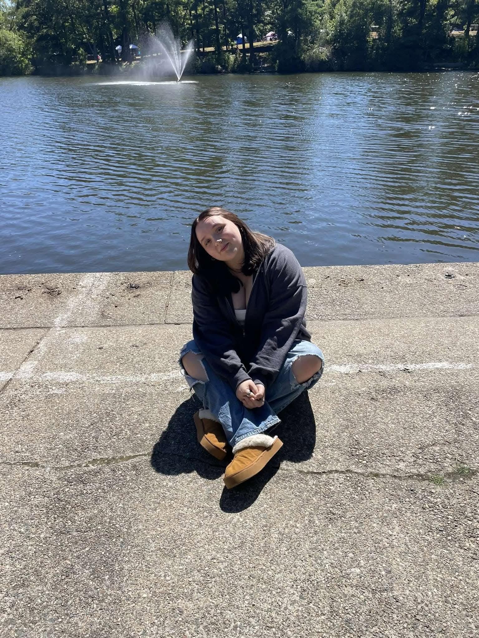 Kylee sitting near the water